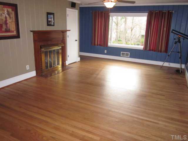 5316 Barclay Drive Raleigh, NC 27606 - Photo 14 of 25 Another nice view of the lovely living room with masonry fireplace with gas logs! Huge front window provides for lots of natural light! Living room is complete with hardwood floors!