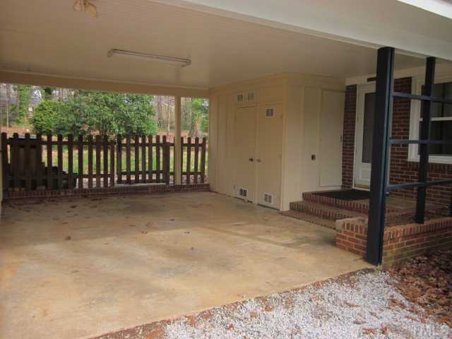 5316 Barclay Drive Raleigh, NC 27606 - Photo 3 of 25 Nice view of the large open carport with lots of walk in storage! View looks into the fenced in backyard with lots of mature trees! So many conveniences only minutes away to include Rex Hospital, Crabtree Valley Mall and so much more!