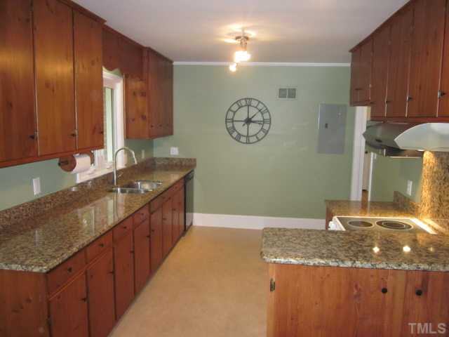 5316 Barclay Drive Raleigh, NC 27606 - Photo 7 of 25 Adorable kitchen has been updated with granite counter tops, microwave, stainless steel upgraded range hood, smooth top stove and range, black dishwasher, custom bar with granite and knotty pine cabinets!