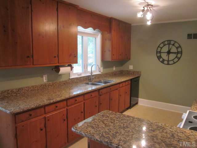 5316 Barclay Drive Raleigh, NC 27606 - Photo 8 of 25 Another nice view of this adorable kitchen featuring upgraded granite counter tops, new goose neck faucet and under mounted stainless steel sink, new lights, kitchen light and bar light on dimmer!