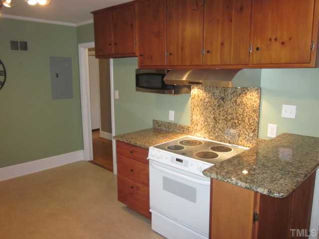 5316 Barclay Drive Raleigh, NC 27606 - Photo 9 of 25 Yet another lovely look at this cute kitchen featuring granite counter tops, custom bar, knotty pine cabinets with new hardware, stainless steel microwave and stainless steel upgraded range hood!