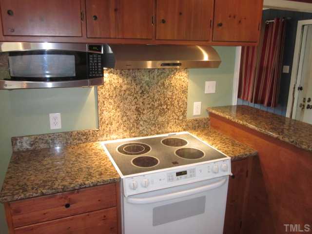 5316 Barclay Drive Raleigh, NC 27606 - Photo 10 of 25 One last view of this adorable kitchen! Kitchen has been nicely upgraded with granite counter tops, custom bar with granite, new goose neck faucet and under mounted stainless steel sink! New lights!