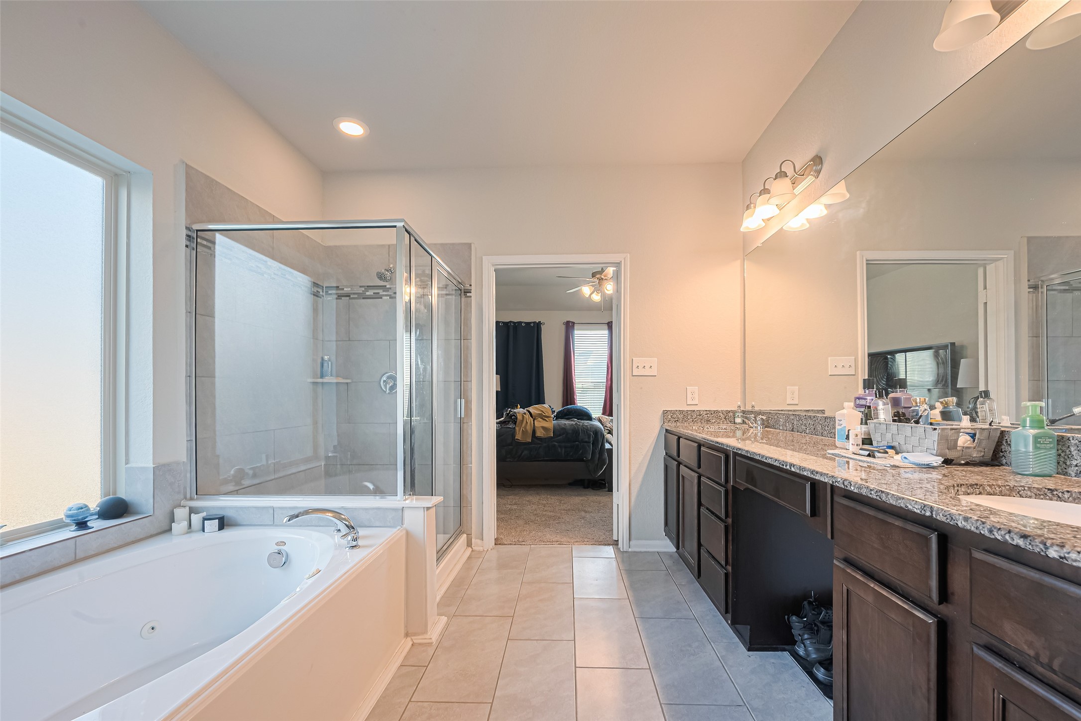 4507 Shallow Hill Court Houston, TX 77084 - Photo 12 of 50 a spacious bathroom with a tub sink shower and mirror