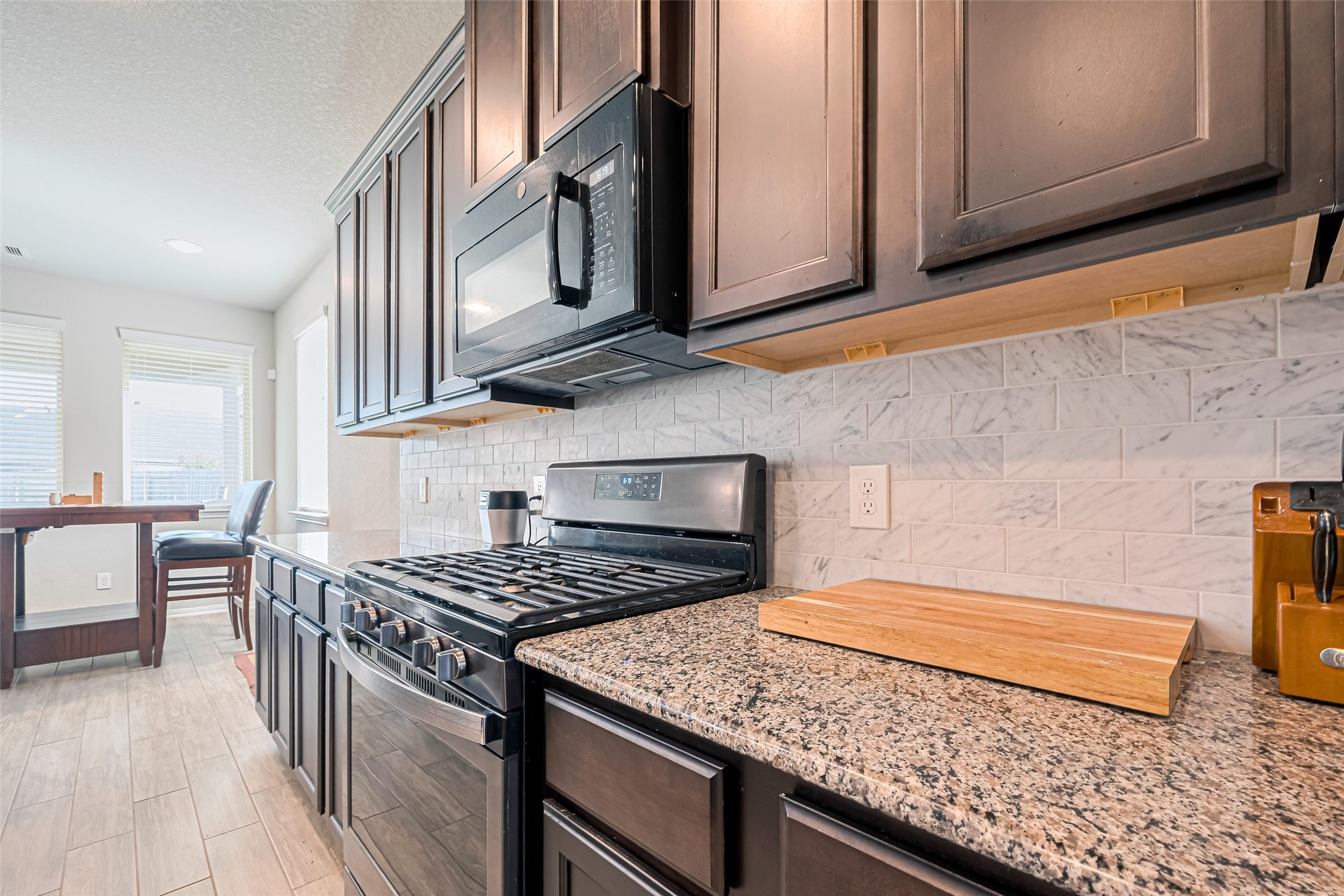 4507 Shallow Hill Court Houston, TX 77084 - Photo 15 of 50 a kitchen with stainless steel appliances granite countertop a stove a sink and a microwave