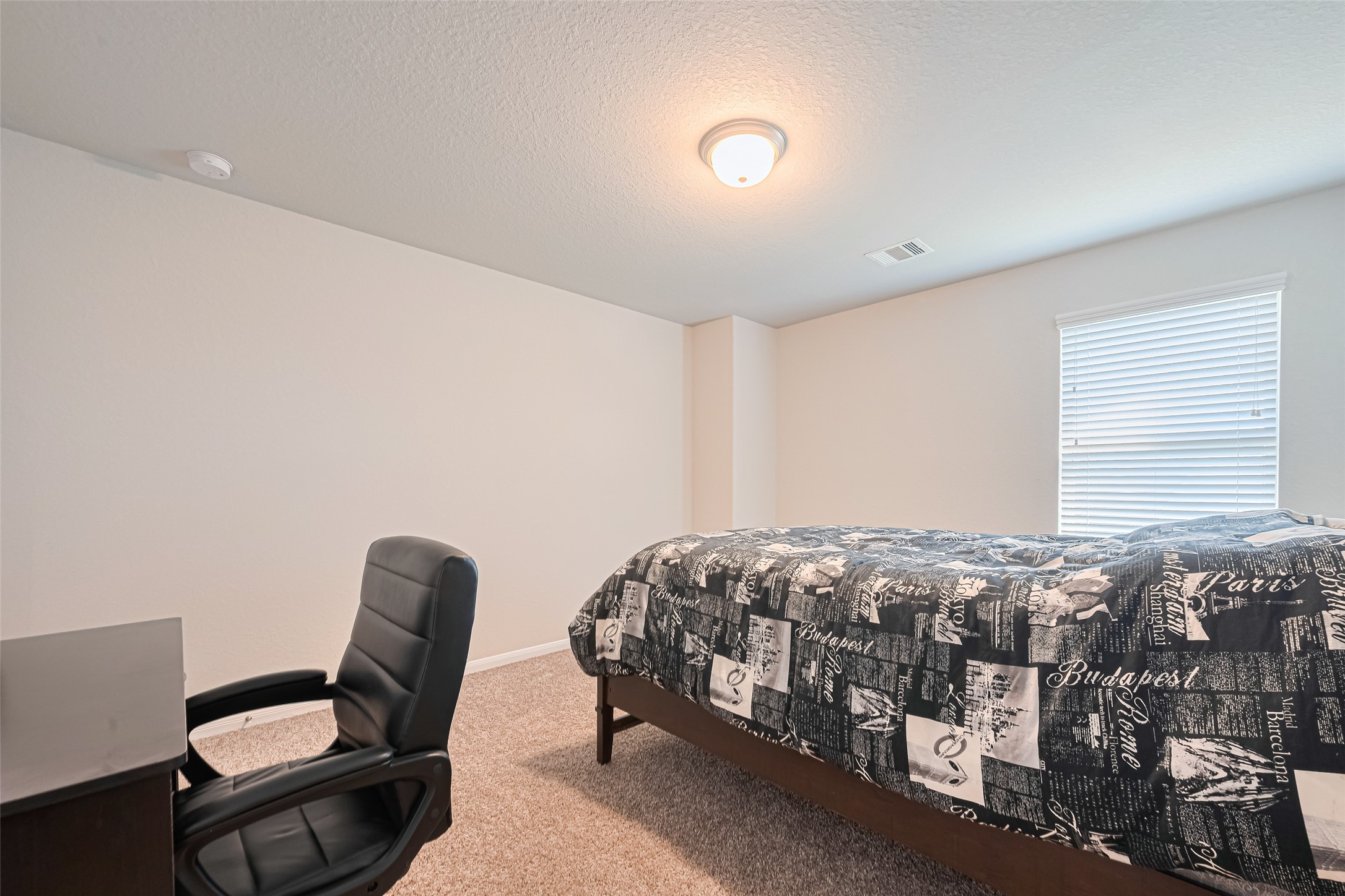 4507 Shallow Hill Court Houston, TX 77084 - Photo 23 of 50 a bedroom with bed and a chair