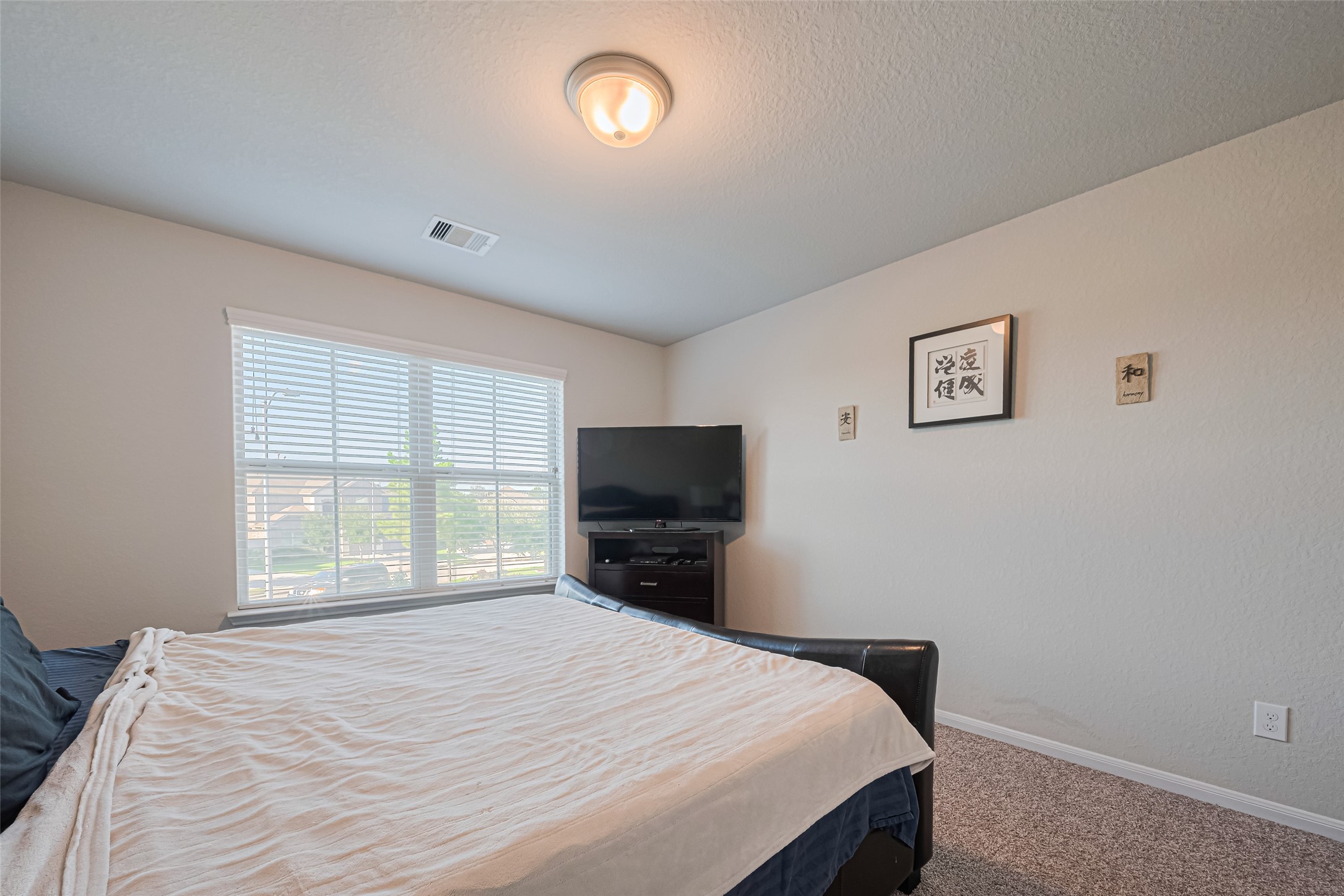 4507 Shallow Hill Court Houston, TX 77084 - Photo 25 of 50 a bedroom with a bed and a flat screen tv