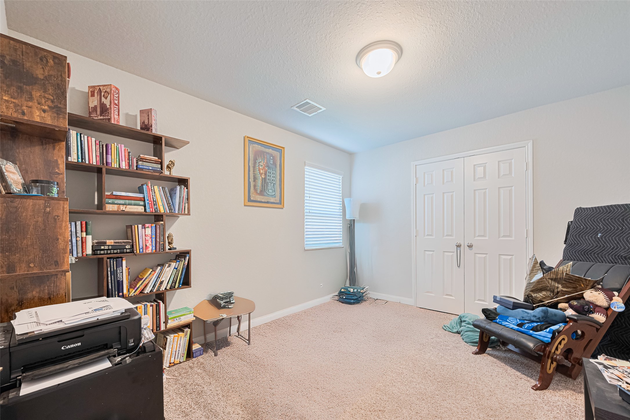 4507 Shallow Hill Court Houston, TX 77084 - Photo 32 of 50 a bedroom with furniture and a book shelf