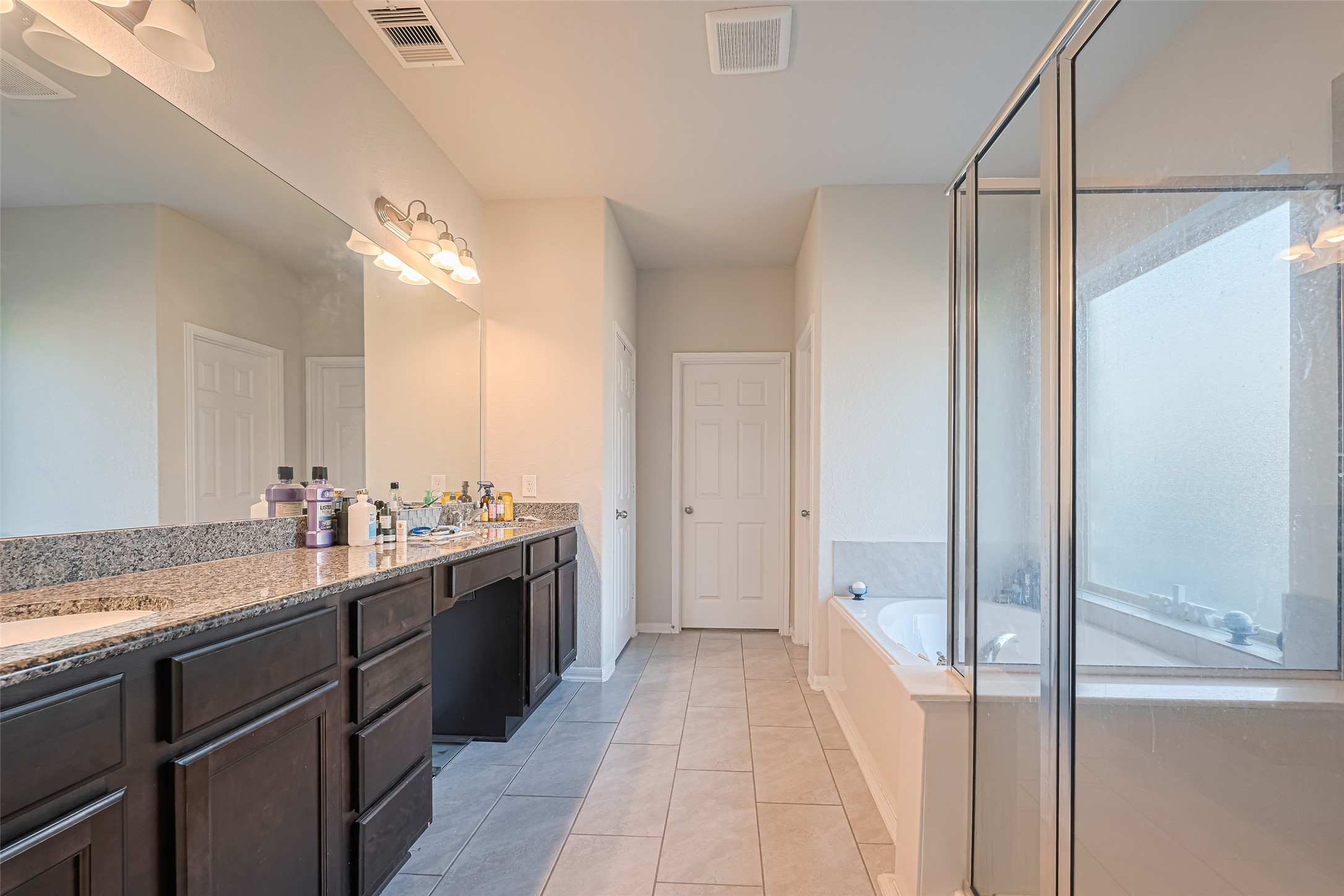 4507 Shallow Hill Court Houston, TX 77084 - Photo 35 of 50 a view of a bathroom with a sink and mirror