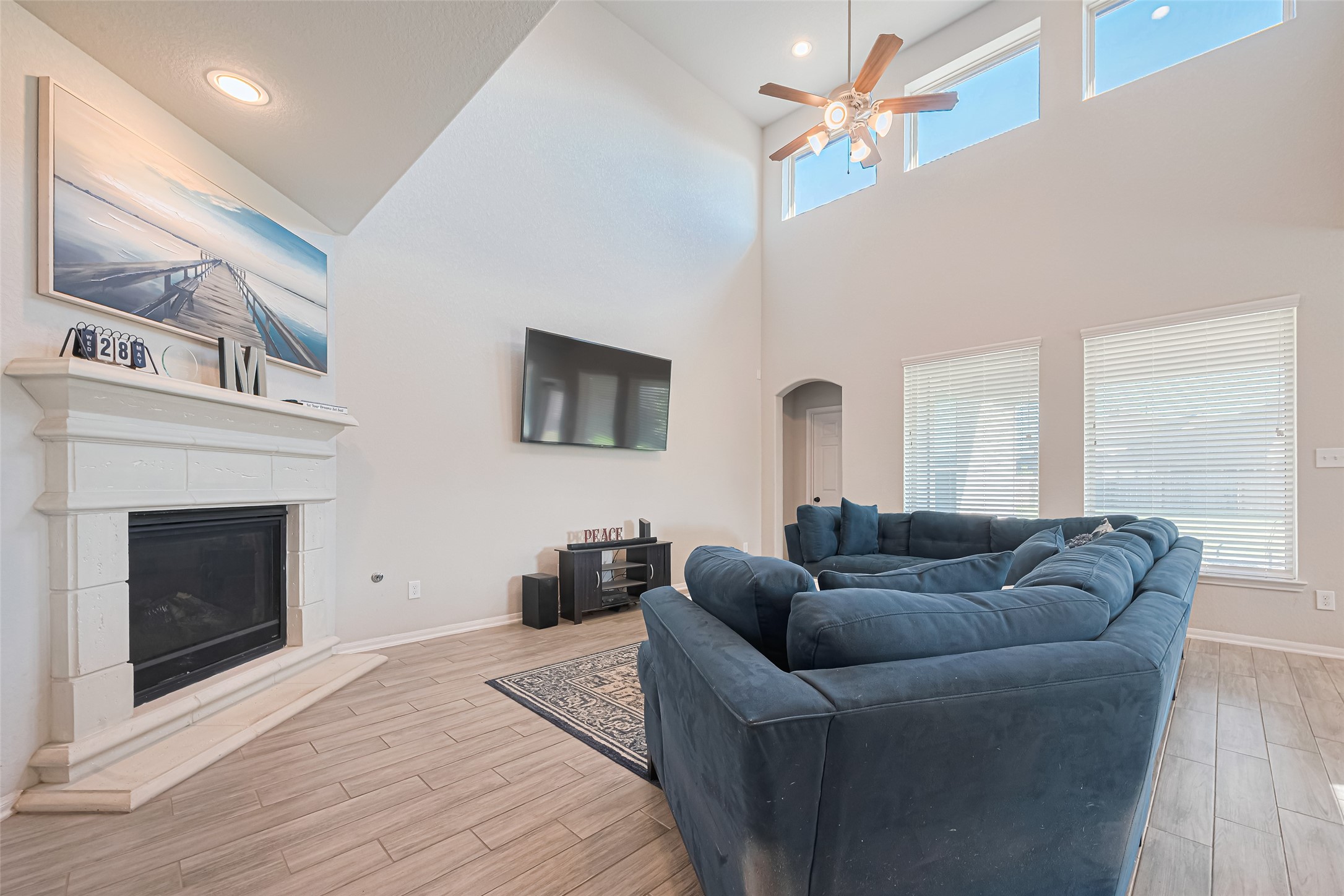 4507 Shallow Hill Court Houston, TX 77084 - Photo 9 of 50 a living room with furniture a flat screen tv and a fireplace