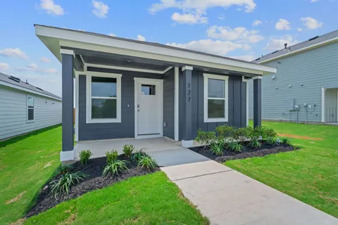 a front view of a house with garden