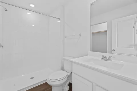 a bathroom with a sink toilet and shower