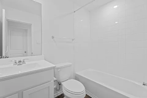a bathroom with a sink toilet vanity and bathtub