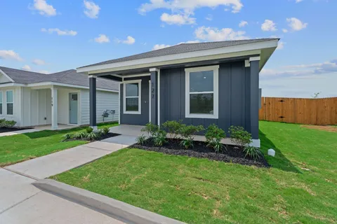 a front view of a house with garden