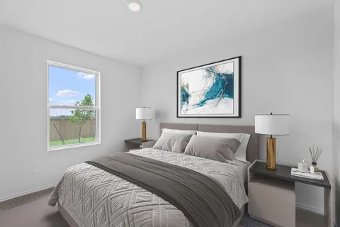 a bedroom with a bed and a painting on the wall