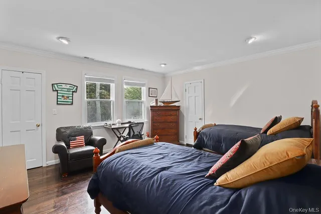 a bedroom with two beds and a couch