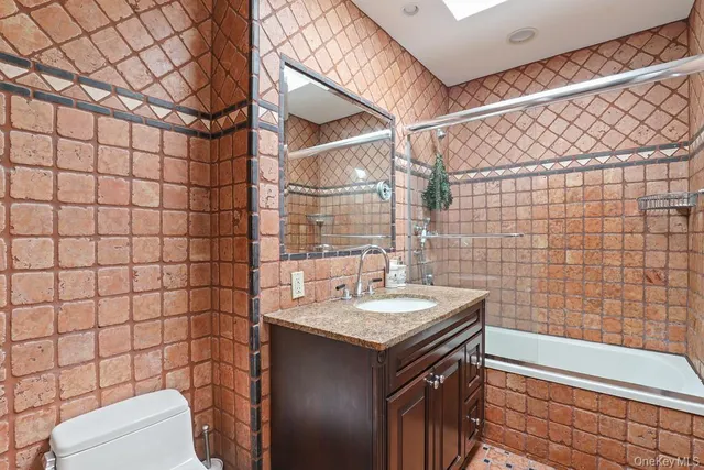 a bathroom with a sink toilet and shower