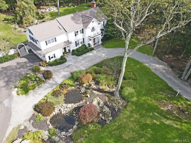 an aerial view of a house with a yard