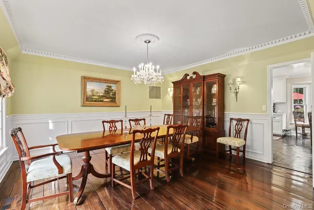 a view of a dining room with furniture and chandelier