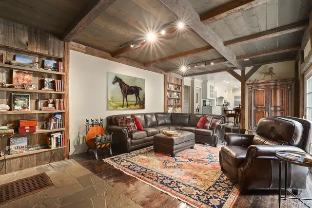 a living room with furniture and a book shelf