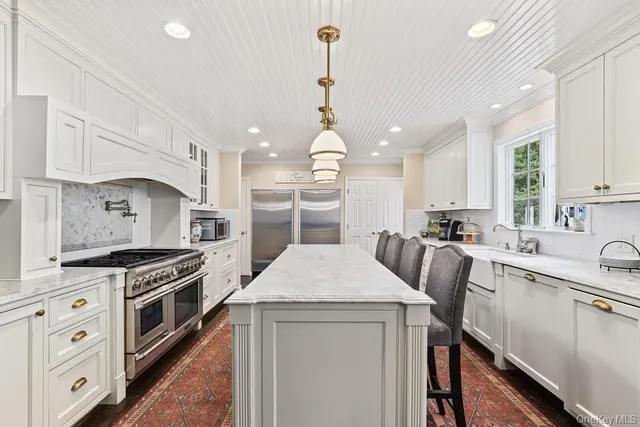 a kitchen with a stove a sink and a refrigerator