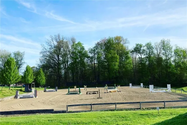 a kitchen with stainless steel appliances granite countertop a sink dishwasher and refrigerator with wooden floor