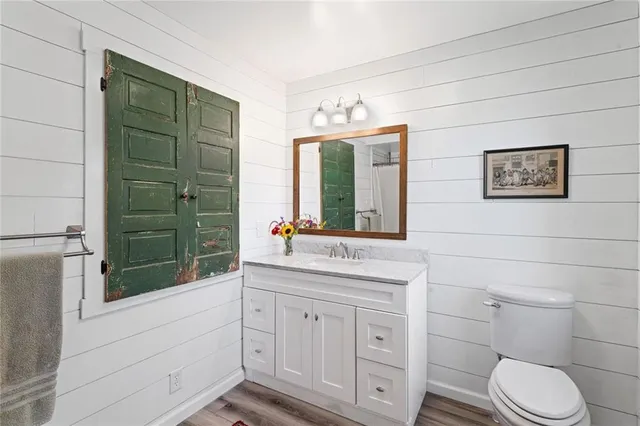 an aerial view of residential houses with outdoor space and trees