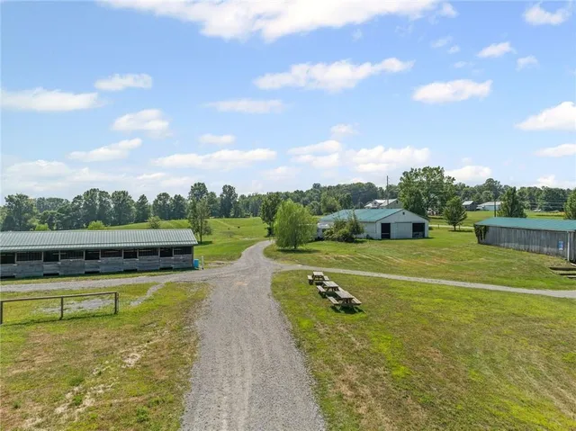 a view of a house with swimming pool and a yard