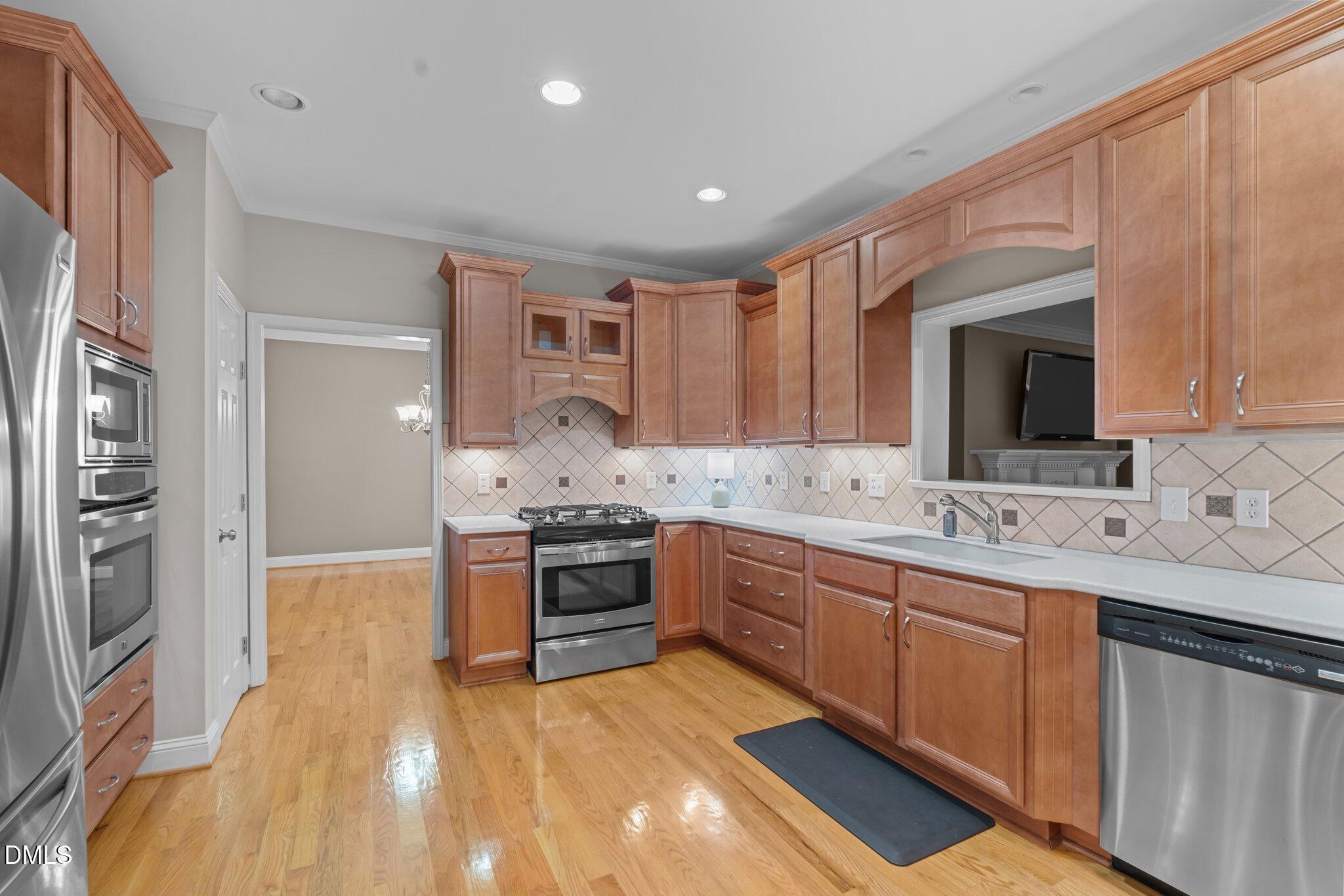 431 Patterson Ridge Lane Sanford, NC 27330 - Photo 5 of 29 a large kitchen with stainless steel appliances granite countertop a stove and a sink