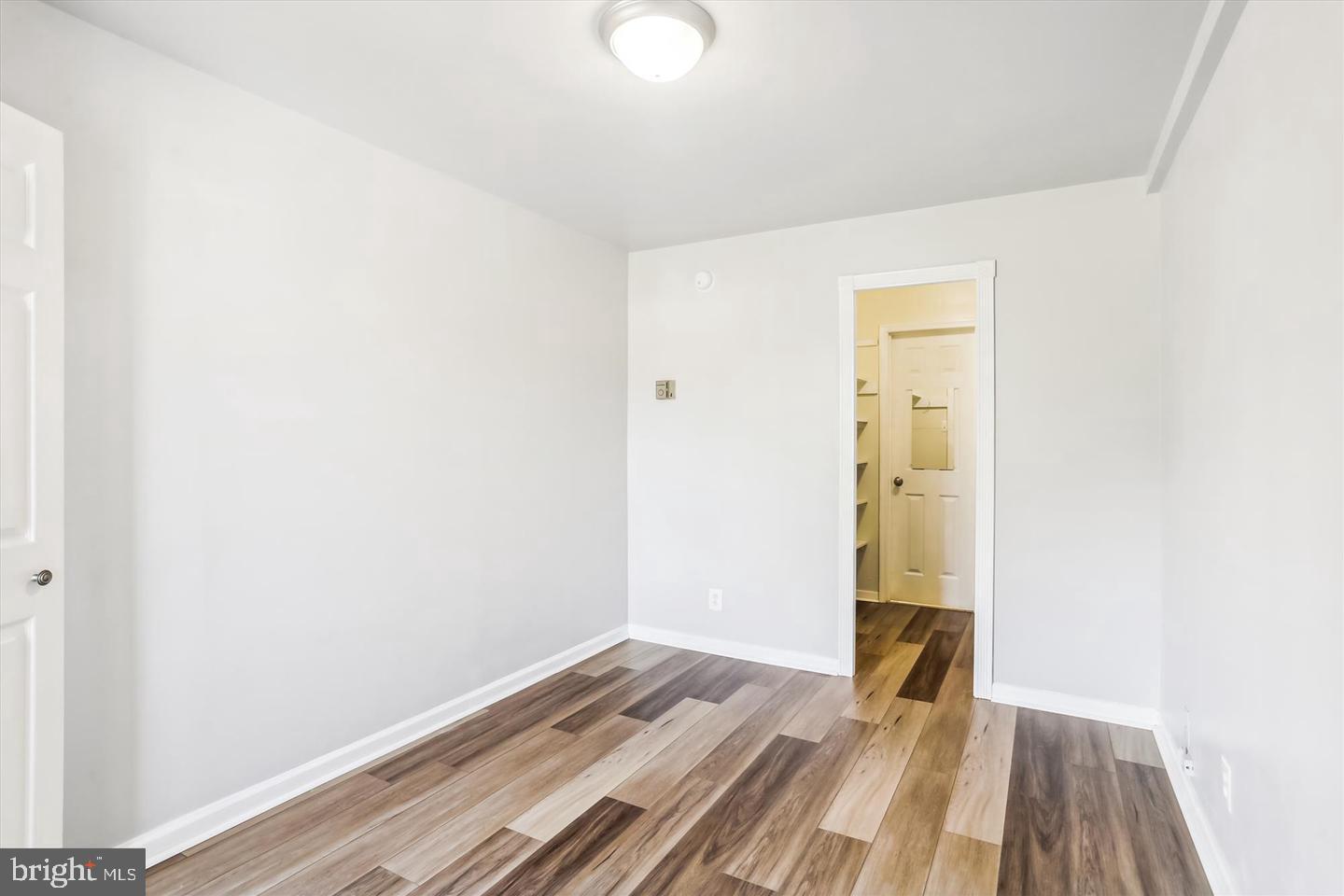 1900 Lyttonsville Road, Unit 602 Silver Spring, MD 20910 - Photo 12 of 43 a view of a room with wooden floor and a bathroom