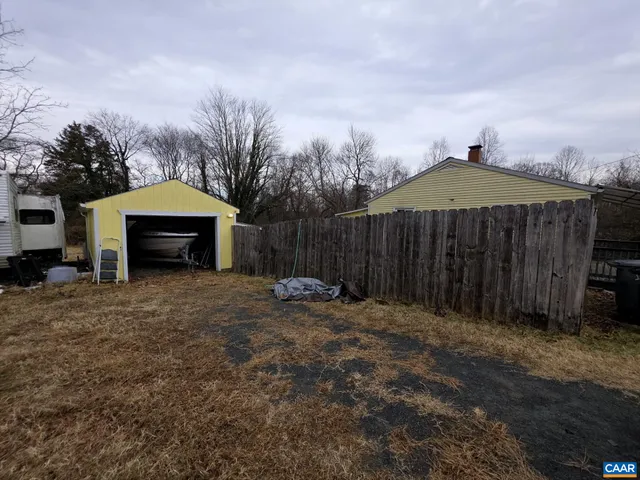 a backyard of a house with yard and outdoor seating