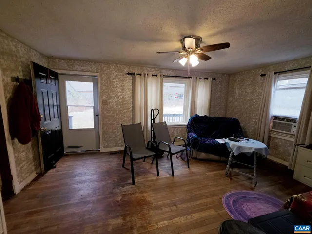 a living room with furniture a window and a flat screen tv