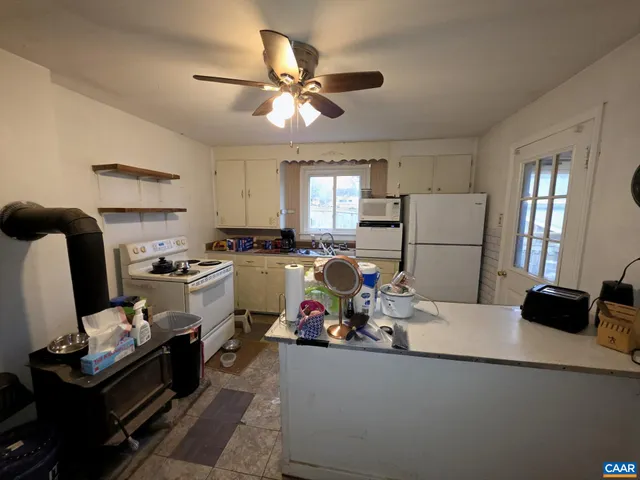 a kitchen with a refrigerator and a stove