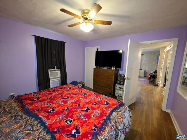 a bed room with a bed and a flat screen tv