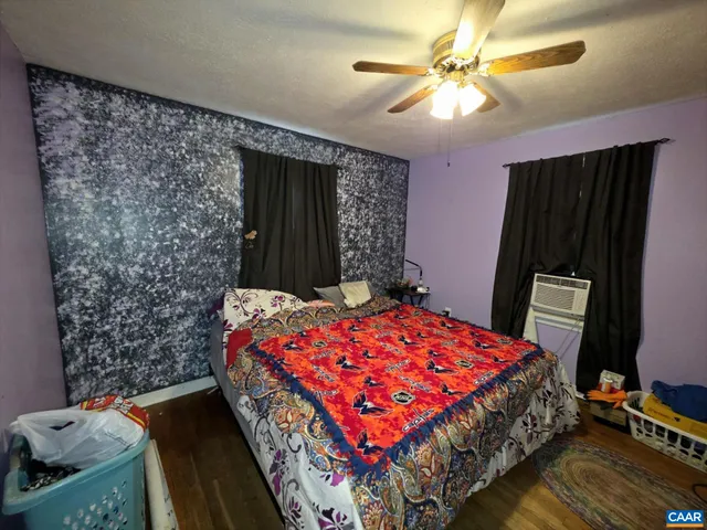 a bedroom with a bed dresser and a window