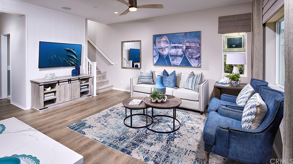 5617 Solstice Way Bonsall, CA 92003 - Photo 2 of 8 a living room with furniture a flat screen tv and a floor to ceiling window