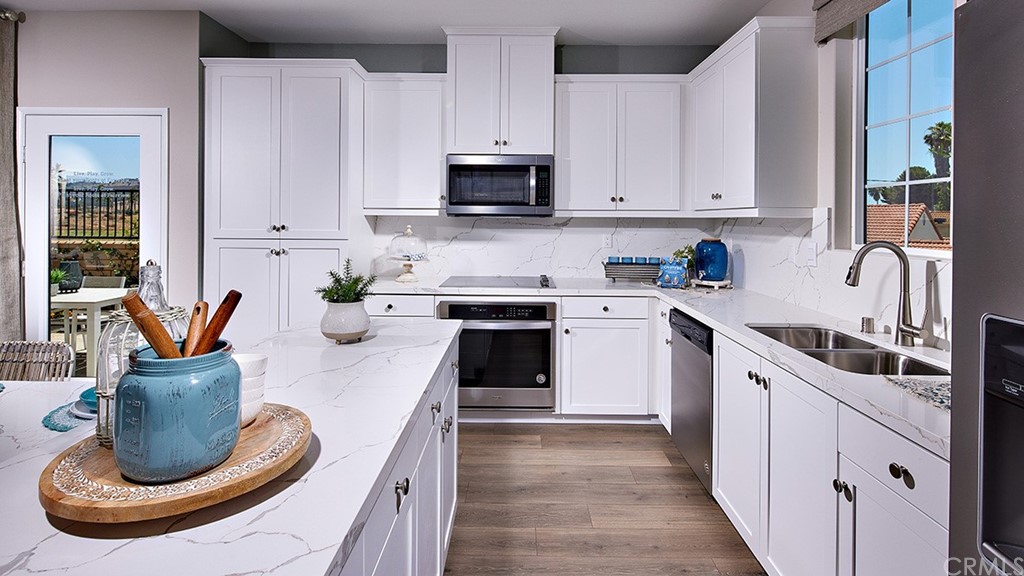 5617 Solstice Way Bonsall, CA 92003 - Photo 3 of 8 a kitchen with stainless steel appliances granite countertop a sink and a stove