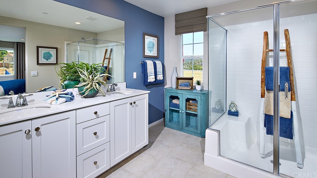 5617 Solstice Way Bonsall, CA 92003 - Photo 7 of 8 a spacious bathroom with a double vanity sink a mirror a and a shower