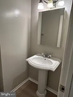 a bathroom with a sink a mirror and a toilet