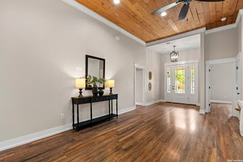 a view of a hallway and wooden floor with workspace