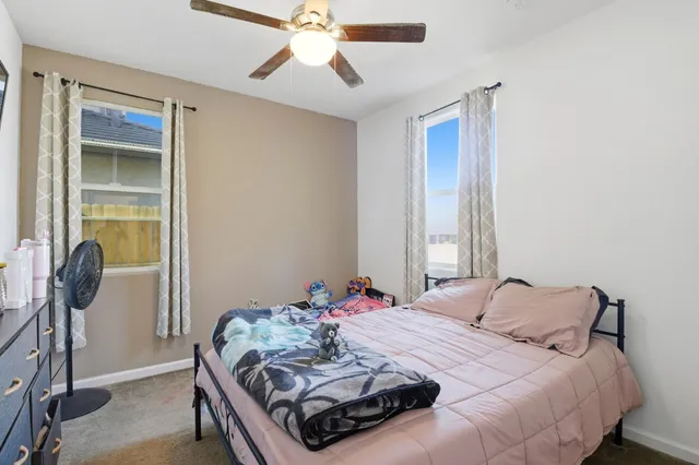 a bedroom with a bed and a desk