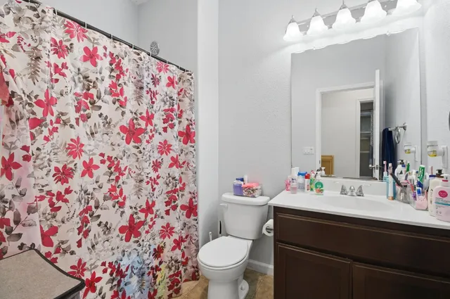 a bathroom with a sink toilet and a mirror