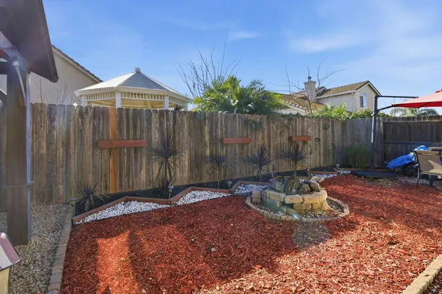 a backyard of a house with table and chairs