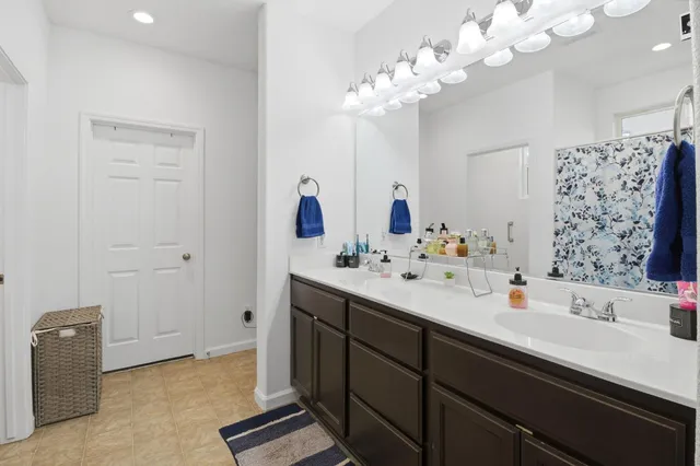a bathroom with a sink a mirror and a shower