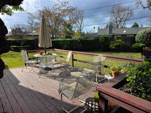 a view of a patio with couches table and chairs and potted plants