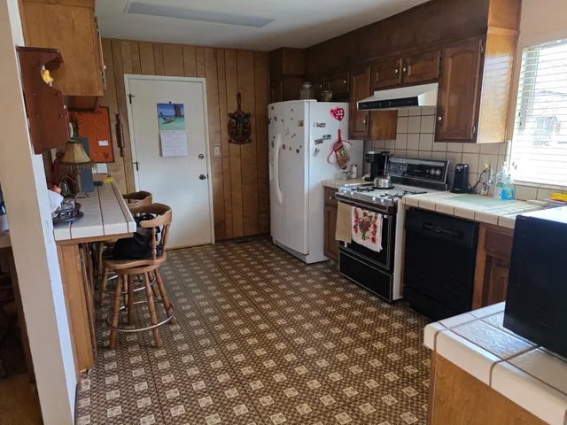 a kitchen with stainless steel appliances a stove a refrigerator and a refrigerator