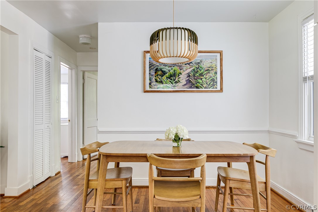 8934 Elm Road Richmond, VA 23235 - Photo 14 of 37 a view of a dining room with furniture wooden floor and a chandelier