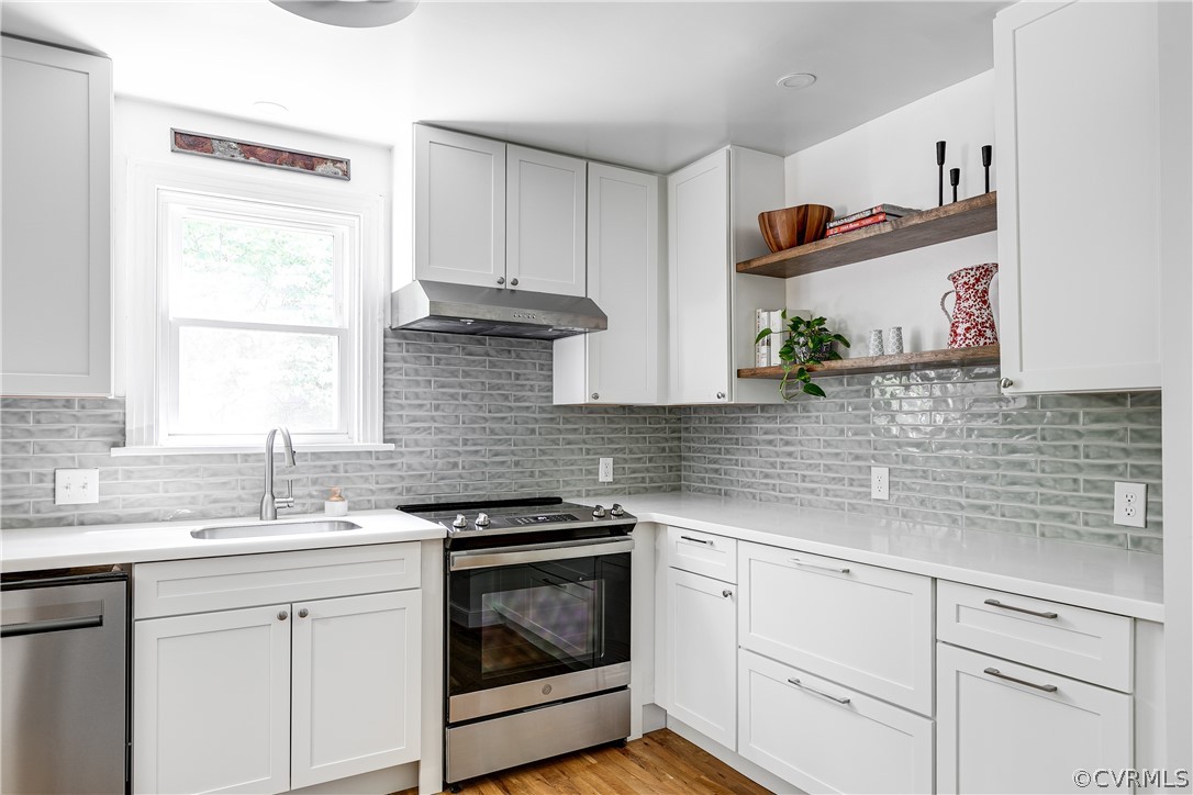 8934 Elm Road Richmond, VA 23235 - Photo 17 of 37 a kitchen with stainless steel appliances white cabinets and a sink