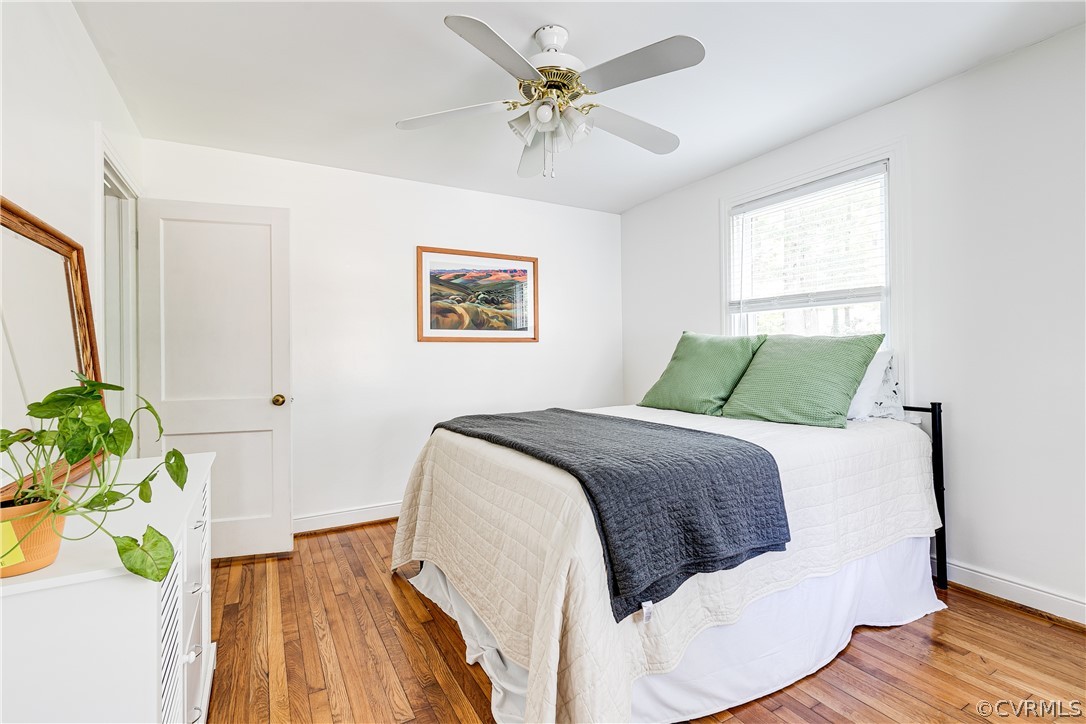8934 Elm Road Richmond, VA 23235 - Photo 22 of 37 a bedroom with a bed and a chandelier