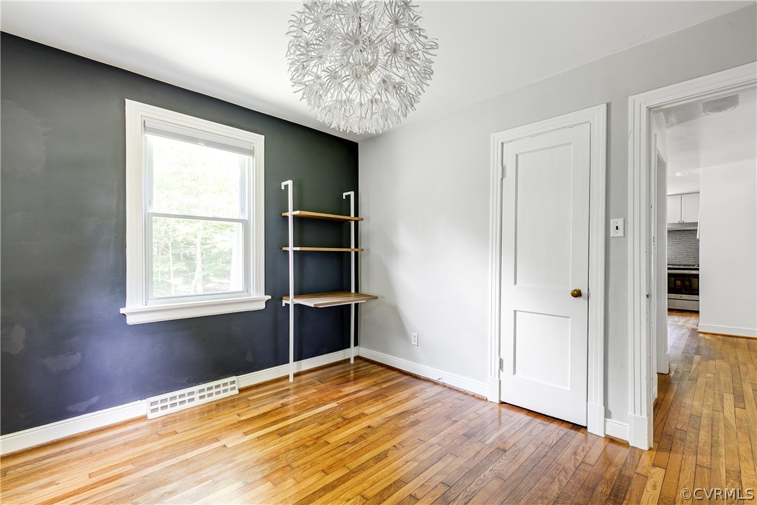 8934 Elm Road Richmond, VA 23235 - Photo 24 of 37 a view of an empty room with wooden floor and a window