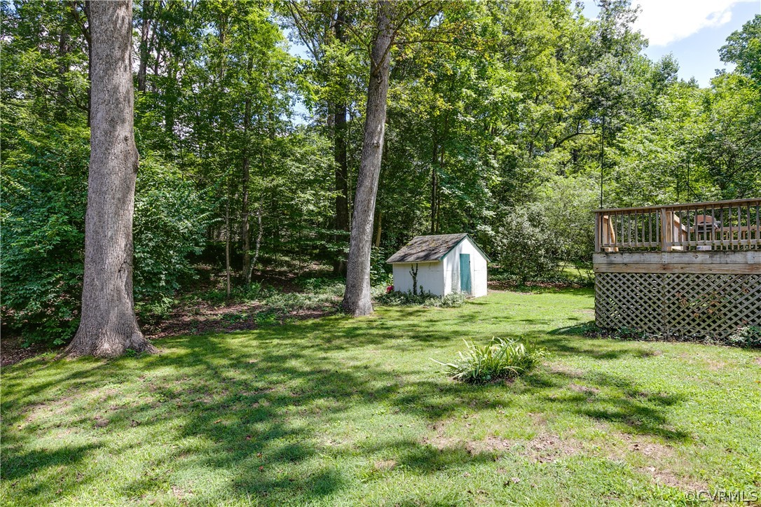 8934 Elm Road Richmond, VA 23235 - Photo 31 of 37 a view of a backyard with large trees and wooden fence